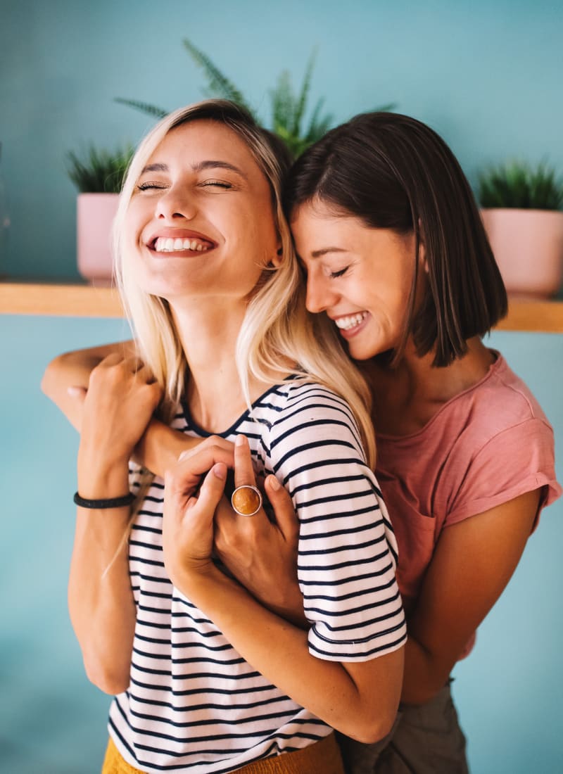Friends embracing at Marquis at Canyon Ridge in Austin, Texas