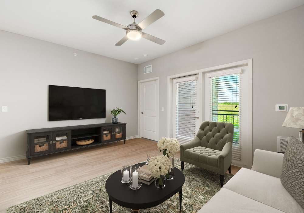 Living room with balcony access at Redwood in San Marcos, Texas