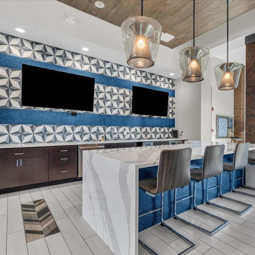 Modern kitchen with stylish bar seating at 81 West Apartments in Fort Myers, Florida
