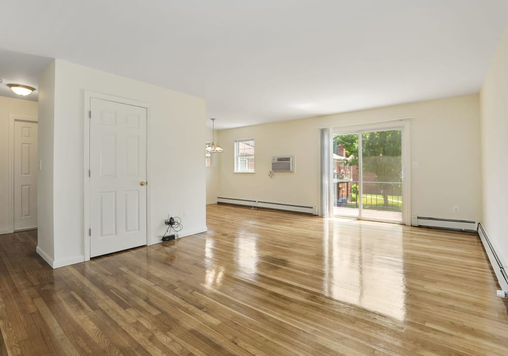 Spacious living room with wood style flooring at Balmoral Arms in Matawan, New Jersey