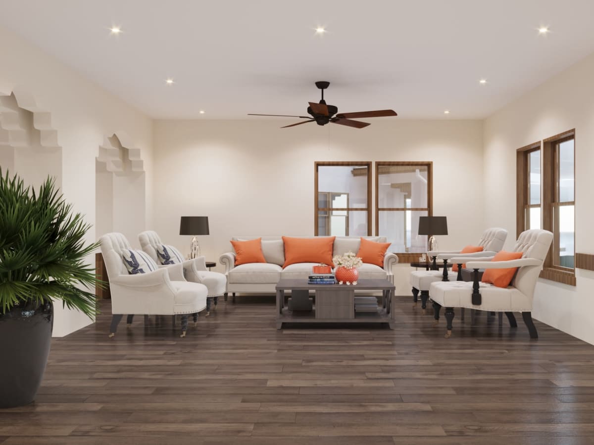 Open sun room with hardwood floor and couches at Ativo Senior Living of Sundance in Buckeye, Arizona