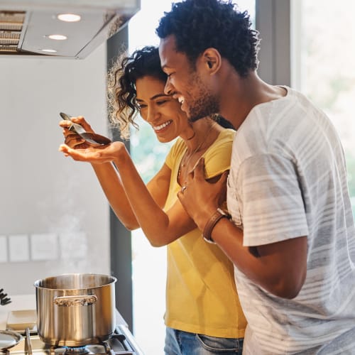 A couple in kitchen testing the food at Eucalyptus Ridge in Lakeside, California