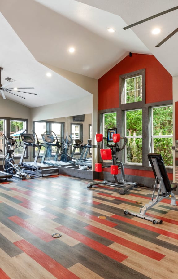 Newly Renovated Fitness Center with Large windows with a view of the pool area at Wildreed Apartments in Everett