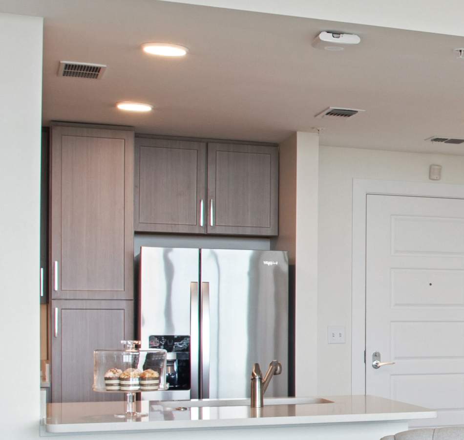 Resident in her modern kitchen at The Village of Southampton in Houston, Texas
