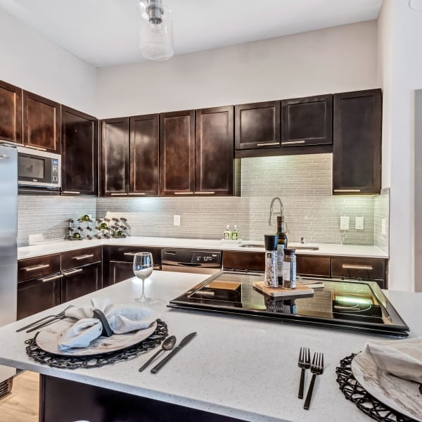 Large kitchen with dark wooden cabinets and white tile backsplash at Bellrock Bishop Arts in Dallas, Texas