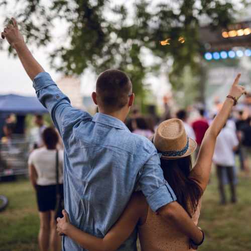 Couple enjoying outdoor concert with raised hands at Terrace at Southern Oaks in Dallas, Texas
