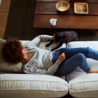 Resident enjoying a restful Sunday in her home at The Sutton Collection in New York, New York