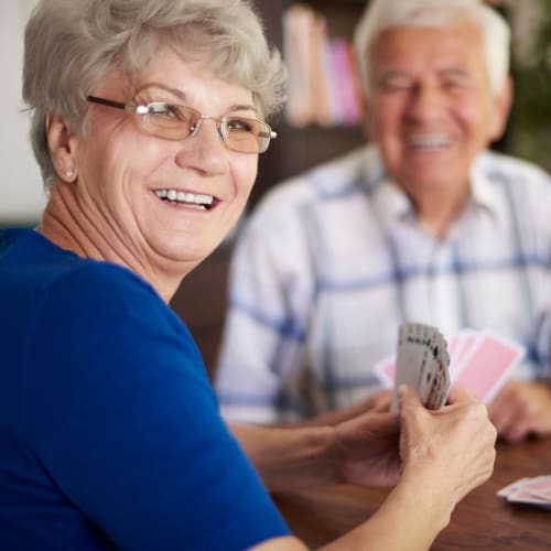 Couple enjoying playing cards together at Oxford Vista Wichita in Wichita, Kansas