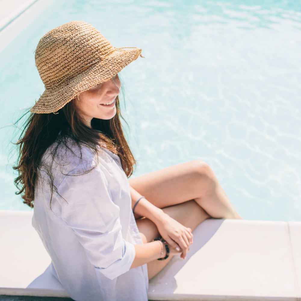 Woman sitting by the pool at The Columns at Westchase in Houston, Texas