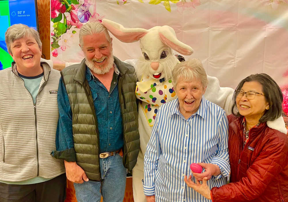 Residents posing with the Easter bunny at Truewood by Merrill, First Hill in Seattle, Washington