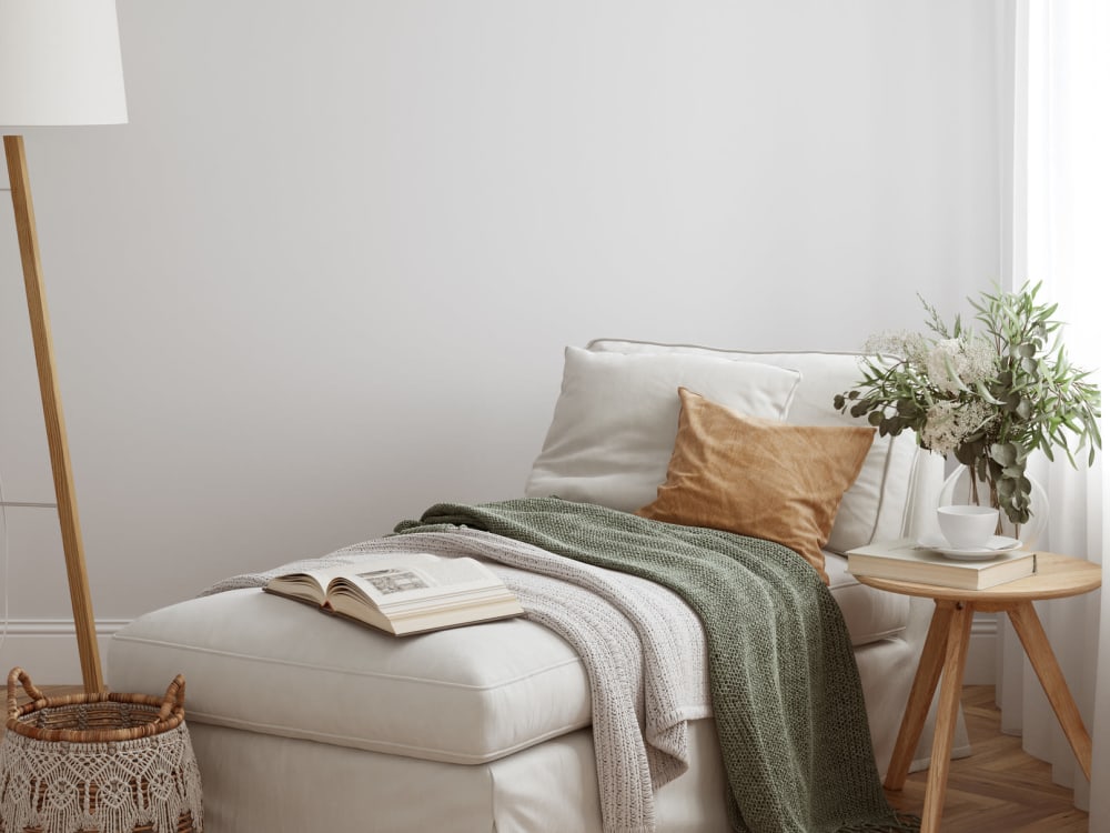 A couch with throw pillows and blankets in an apartment at Pinewood Station in Hillsborough, North Carolina