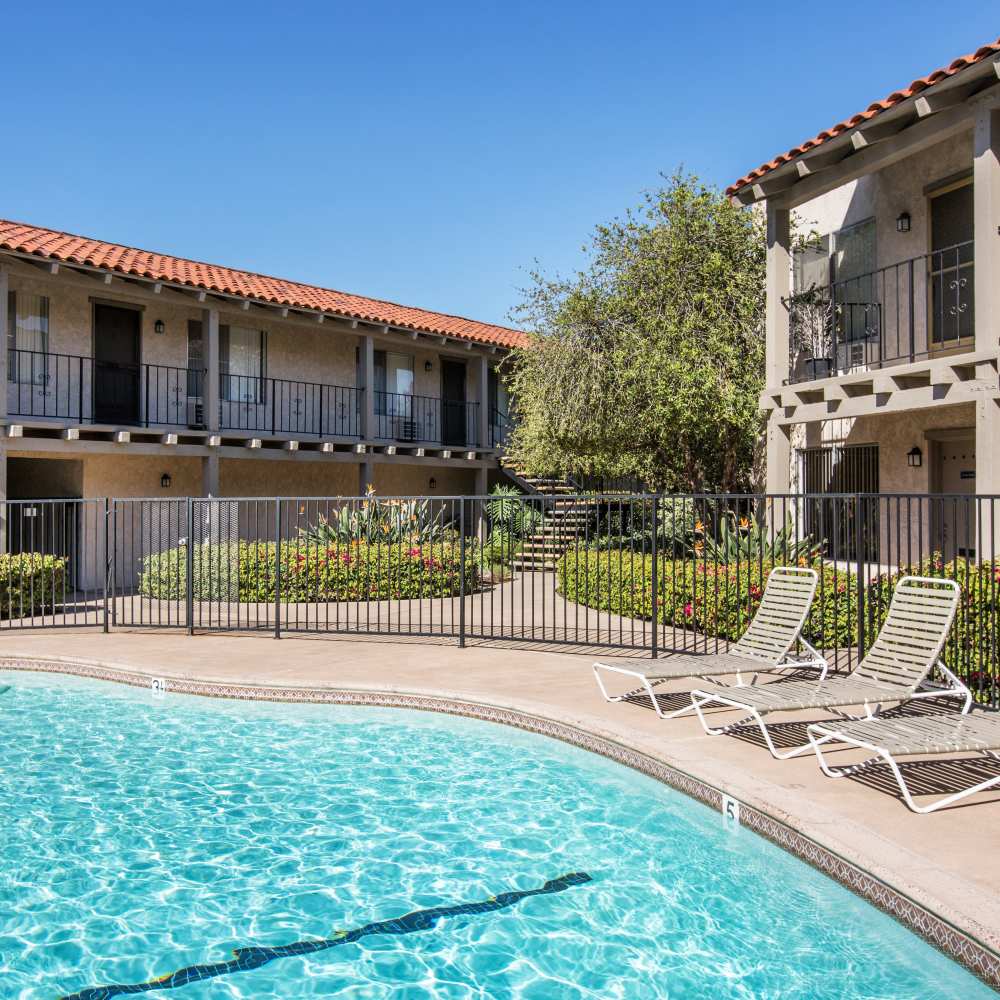 Sparkling pool with lounge chairs at Casa Madrid in Cypress, California