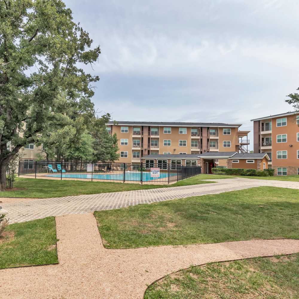 Apartment exterior view with the pool and courtyard view at Regency Gardens in Bryan, Texas