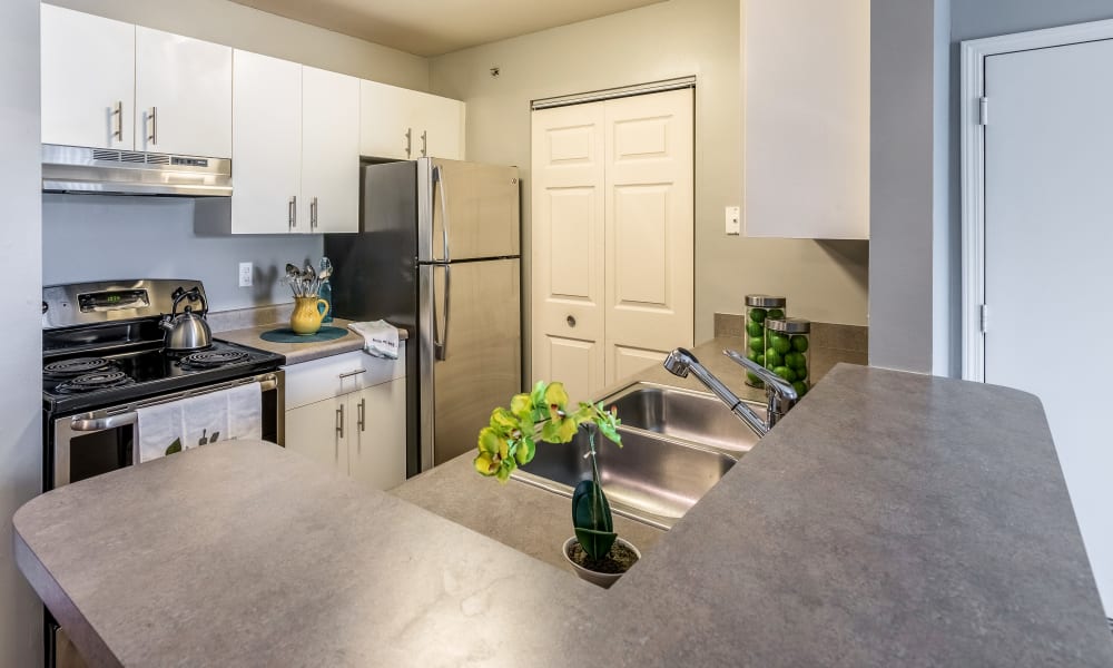 Kitchen and bar at Waters Edge Apartments in Lansing, Michigan