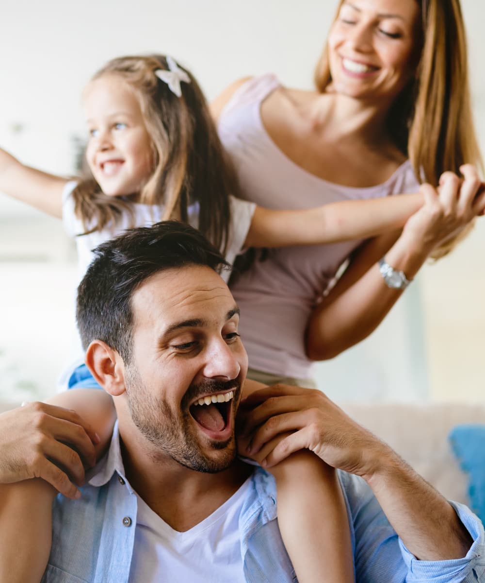 Family enjoying quality time in their modern living room at The View at Lakeside in Lewisville, Texas