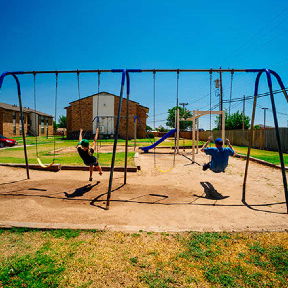 Playground with swing at Cross Timbers At Grand Street in Amarillo, Texas