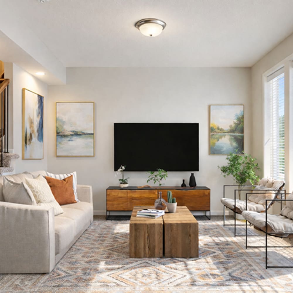 Modern living room with couch, chairs, coffee table and flat screen television at Chapel Ridge in Lees Summit, Missouri