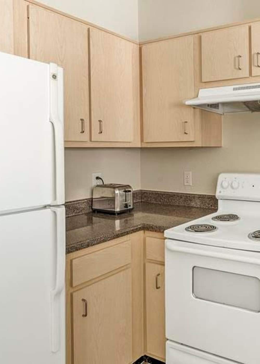 Kitchen with white appliances at Settlers Ranch Apartments in Houston, Texas