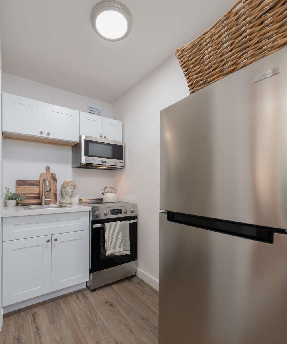 Kitchen with refrigerator at The Theodore in Tacoma, Washington