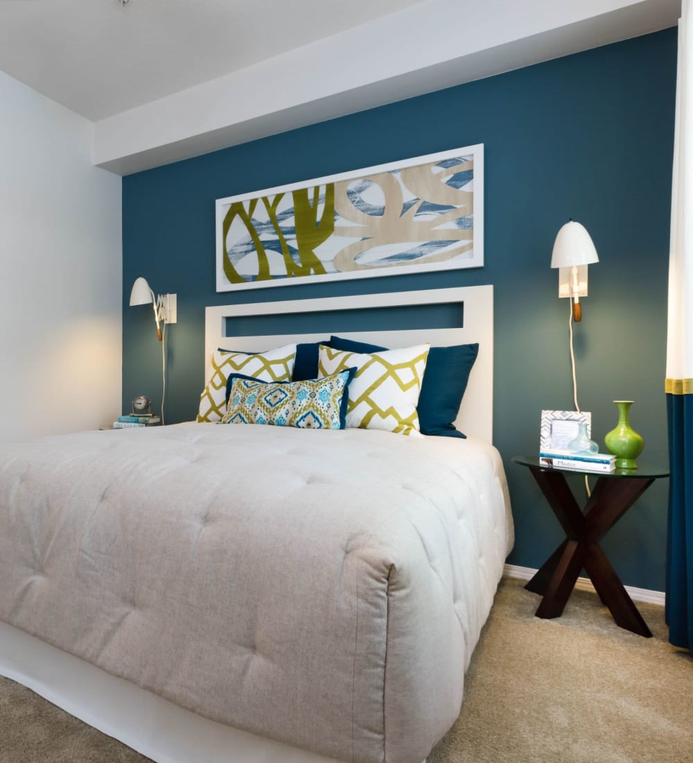 Model bedroom with blue accent wall at Avery at Orenco Station in Hillsboro, Oregon