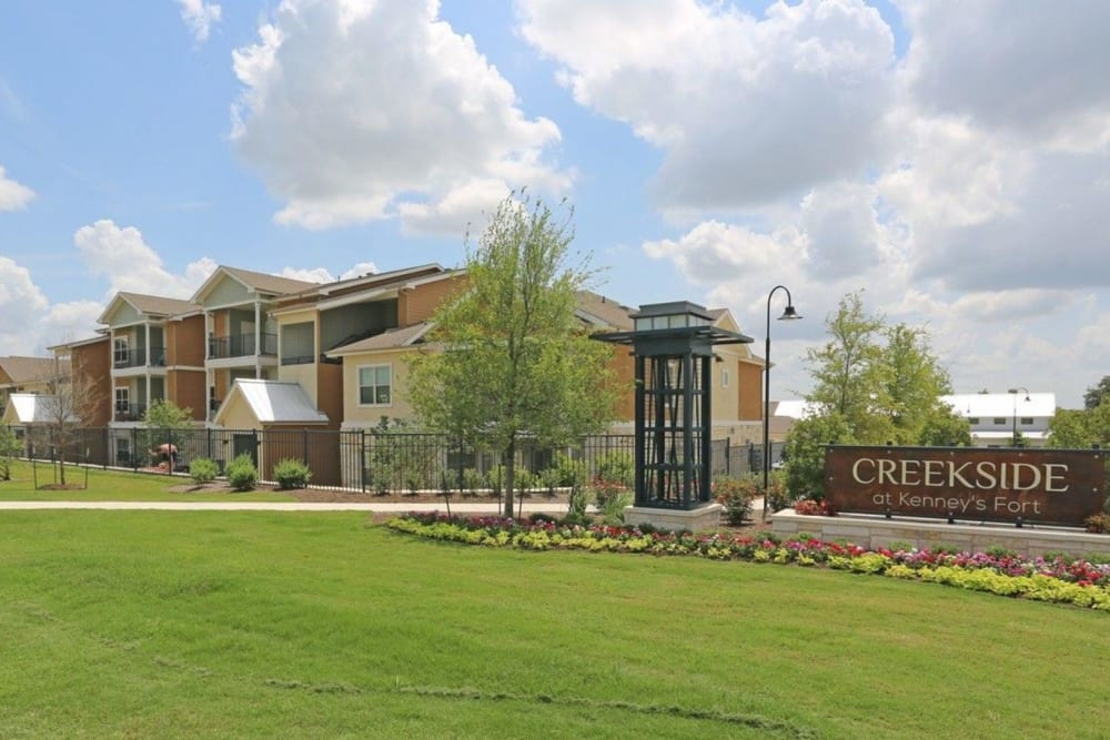 Entrance sign and exterior of the community at Creekside at Kenney's Fort in Round Rock, Texas