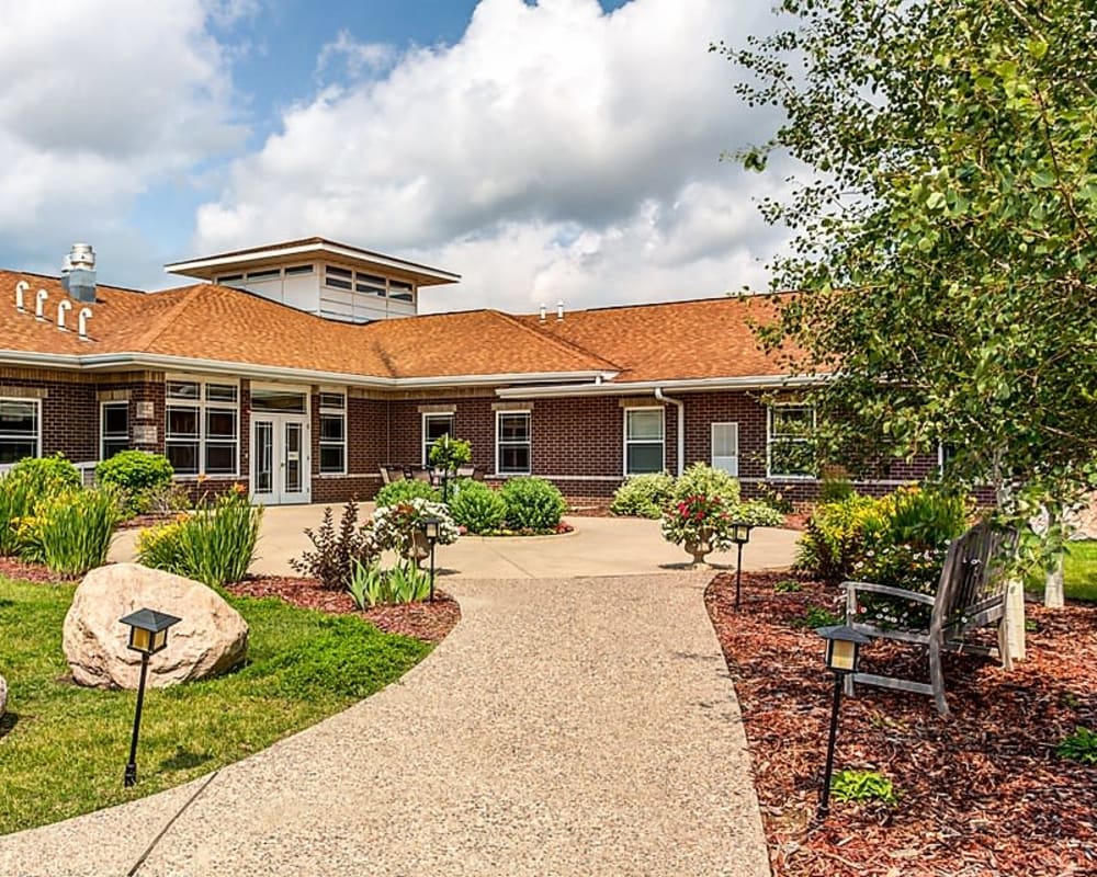 Inviting path with park bench and courtyard at Prairie Hills in Clinton, Iowa.