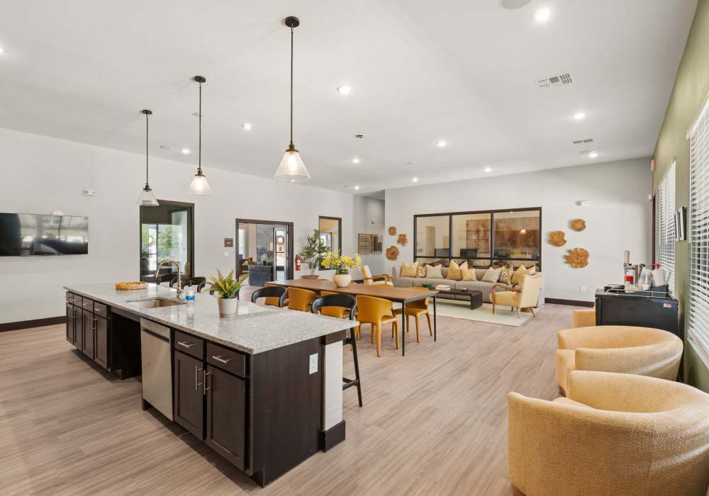 Open clubhouse with kitchen island at Walnut Springs in Seguin, Texas