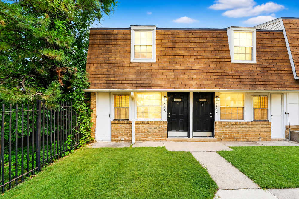 Exterior of building with black door at Pleasant View Townhomes in Baltimore, Maryland