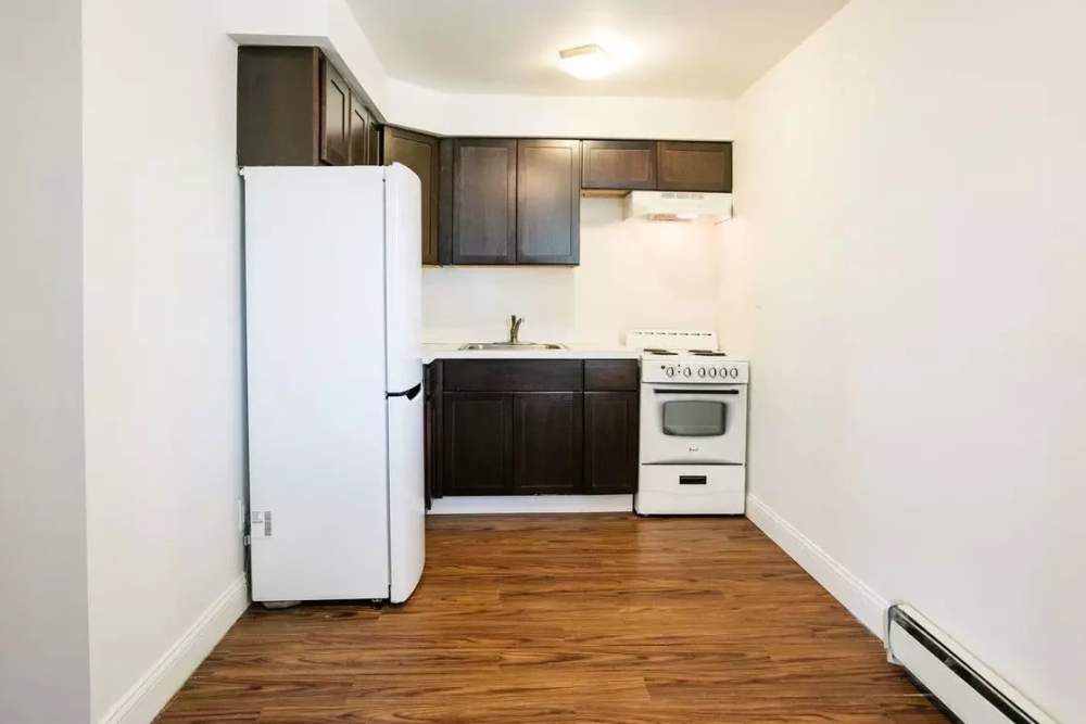 Apartment kitchen with wood-style flooring at Detroit Living in Detroit,Michigan