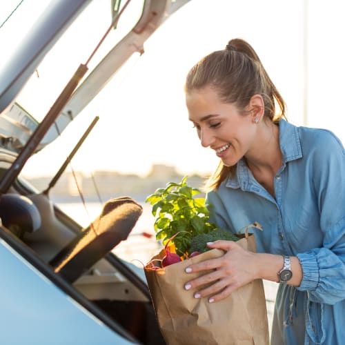 A resident loading groceries into her car near Edson in Oceanside, California