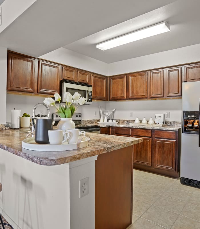 Kitchen with granite countertops at The Park on Westpointe in Yukon, Oklahoma