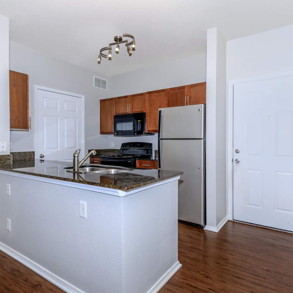 Kitchen with granite countertop and wooden flooring at One Belmar Place in Lakewood,Colorado