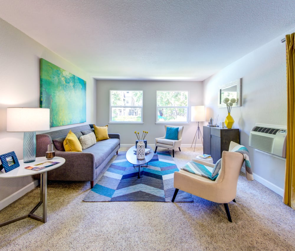 Model living room with plush carpeting and modern furnishings at Sofi Sunnyvale in Sunnyvale, California