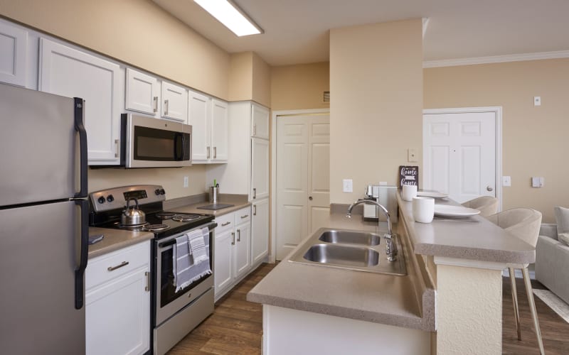 Renovated kitchen with white cabinets at Skyecrest Apartments in Lakewood, Colorado