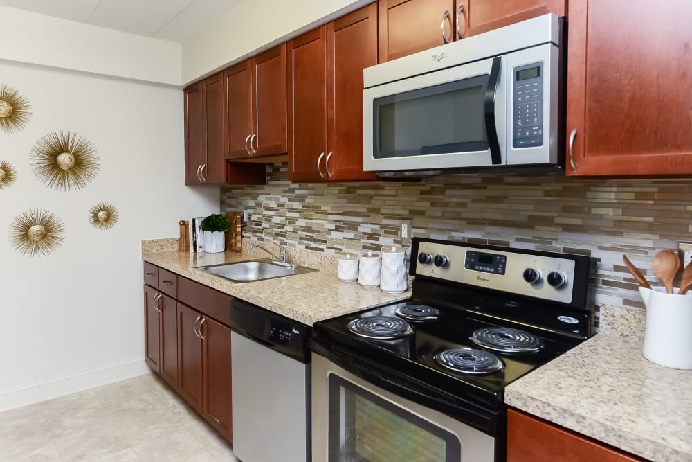 Contemporary kitchen with stainless-steel appliances at Stonegate at Devon Apartments in Devon, Pennsylvania