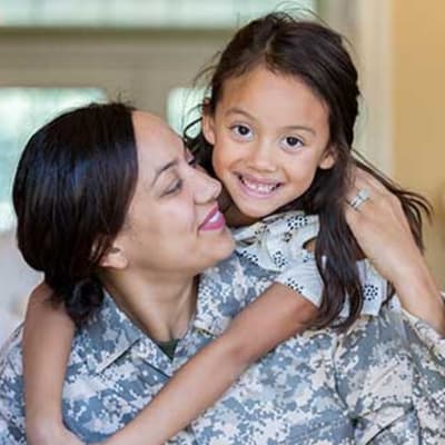 Child hugging woman at The Towne at Northgate Apartments in Colorado Springs, Colorado
