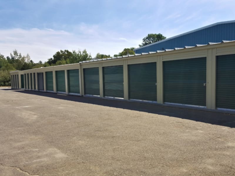 A row of outdoor units with green doors at 603 Storage - Candia in Candia, New Hampshire