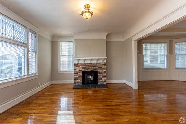 Dining room with hardwood flooring and windows with access to living room at The Miller in Tacoma, Washington