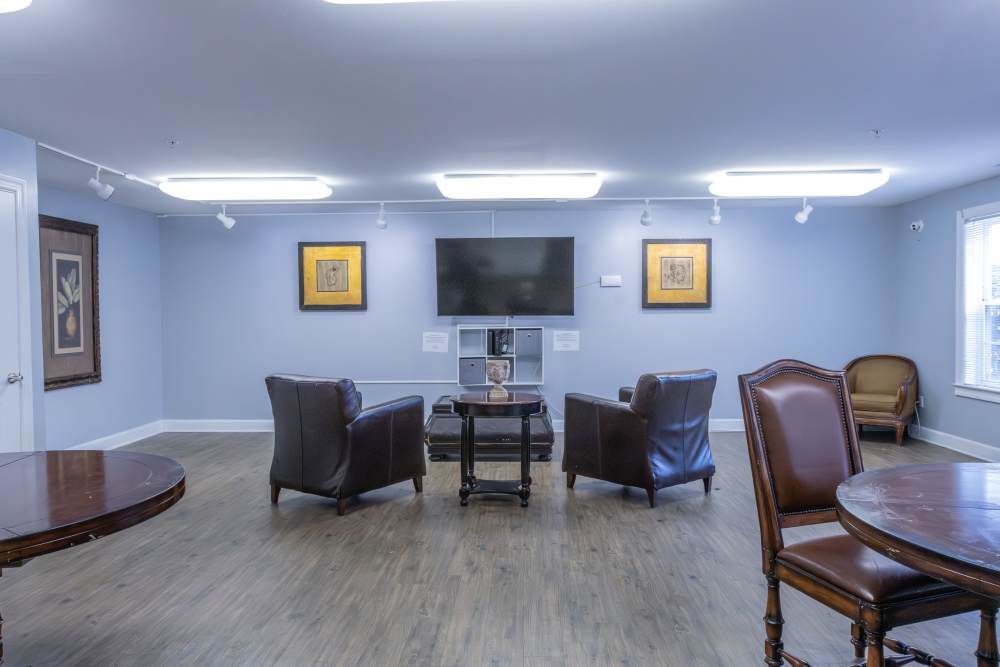 Clubhouse with seating area and flat screen tv at Ashton Walk in Forest Park, Georgia