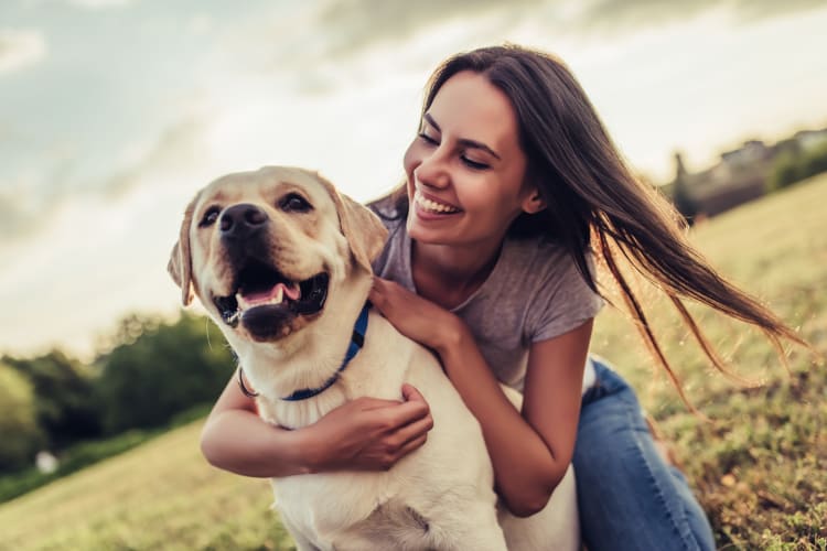 Resident and her dog enjoying their new neighborhood at The Abbey at Sonterra in San Antonio, Texas