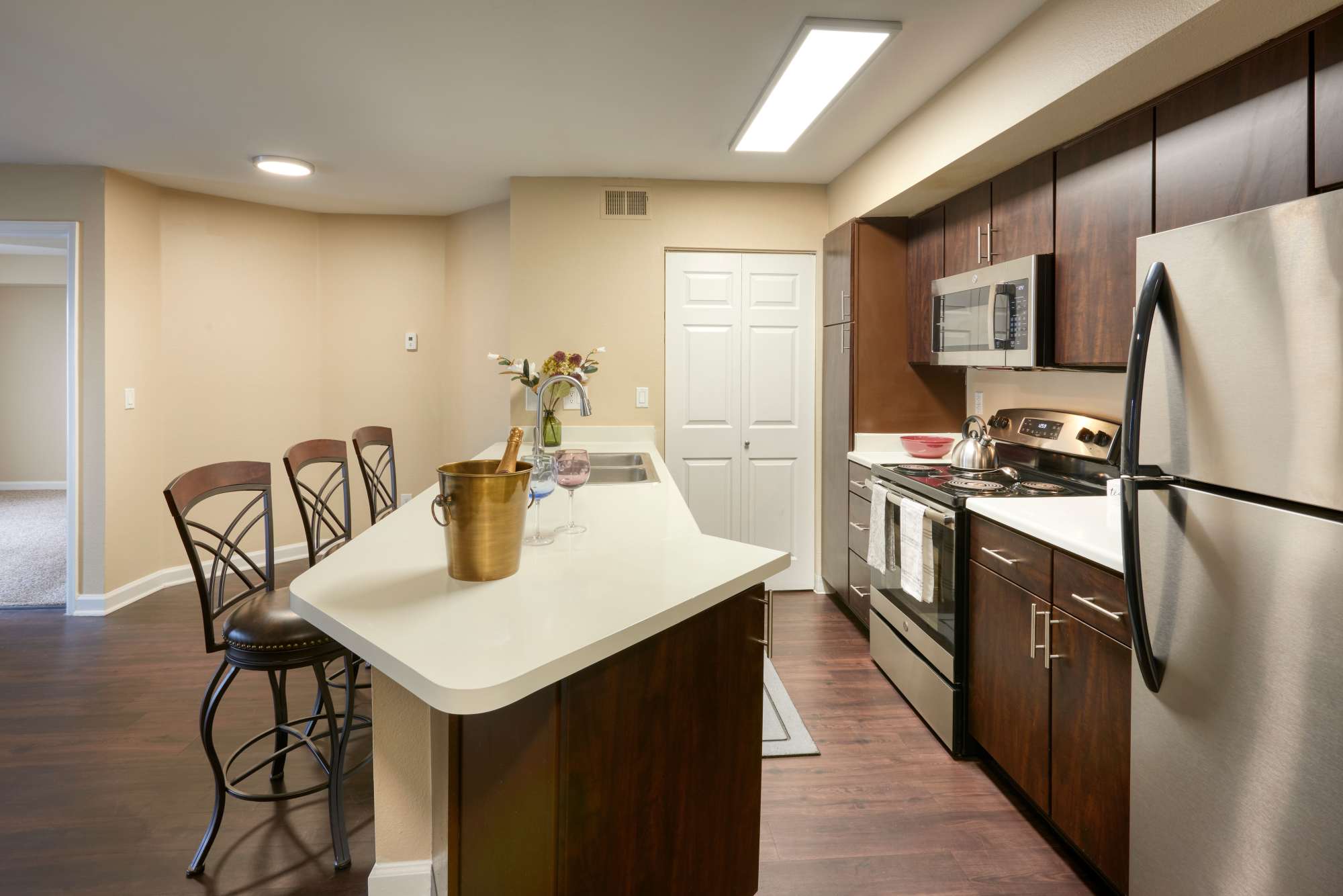 Renovated kitchen with brown cabinets at Villas at Homestead Apartments in Englewood, Colorado