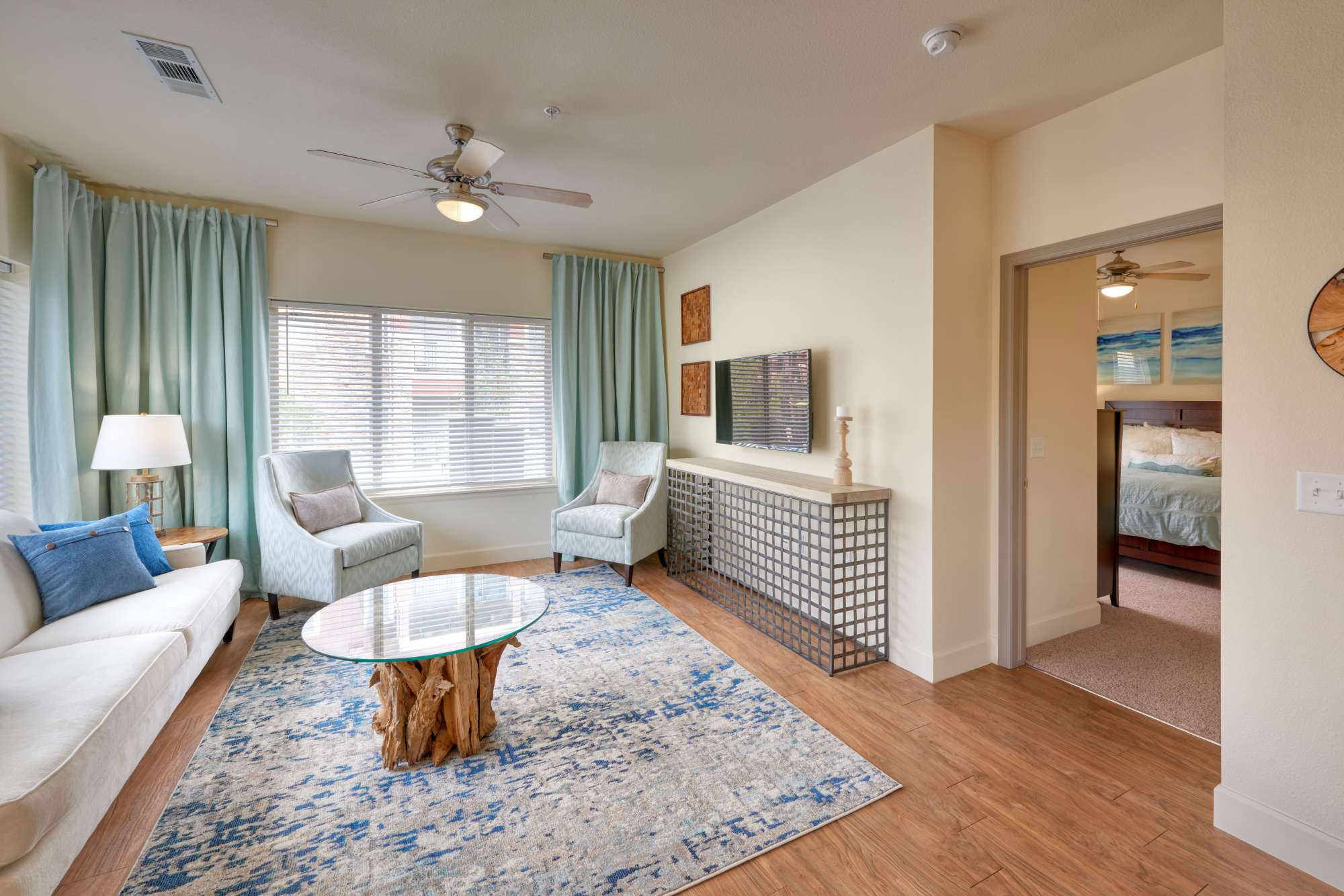 Living room with rug and ceiling fan at M2 Apartments in Denver, Colorado
