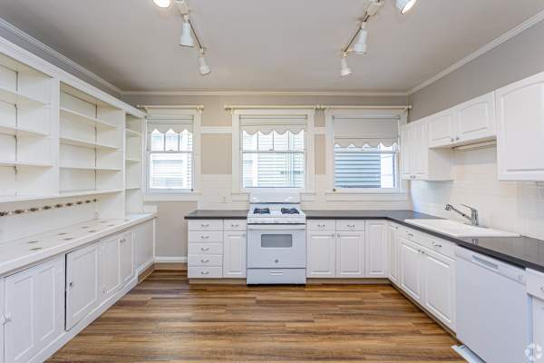 Kitchen with wood style floor, dishwasher, microwave, stove and refrigerator at The Miller in Tacoma, Washington