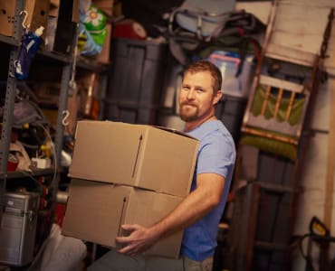 A customer packing his storage unit at AAA Self Storage at Pleasant Ridge Rd in Greensboro, North Carolina.