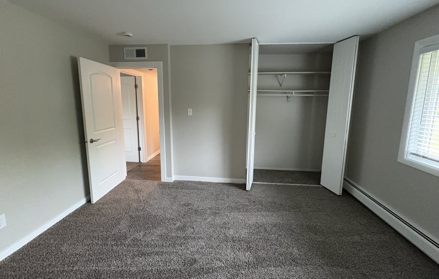 Bedroom with window at Broadway Crossing Apartments in Merrillville, Indiana
