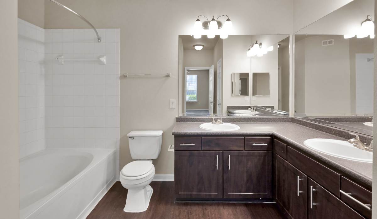 Bathroom with large mirror at Whispering Pines Ranch in The Woodlands, Texas