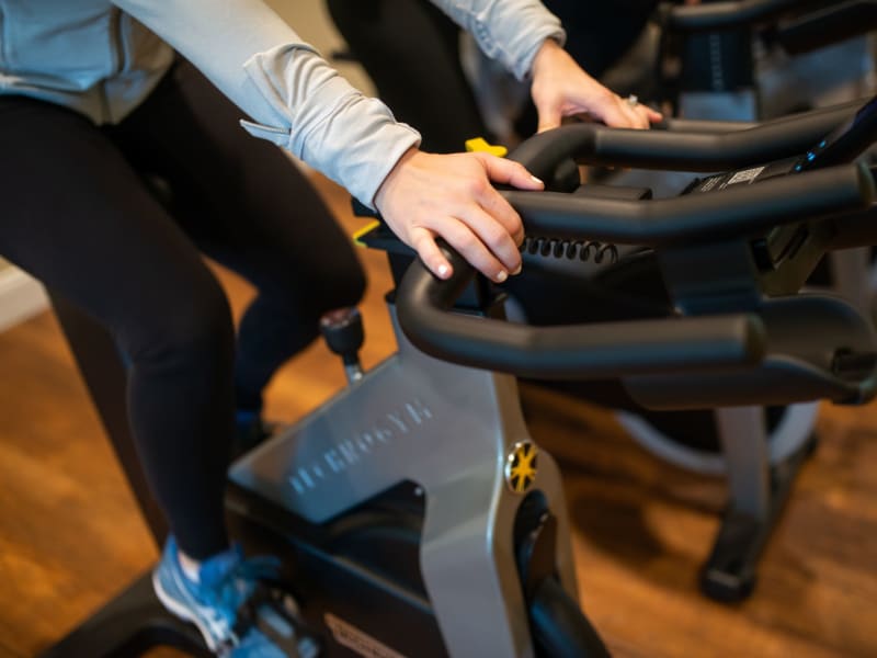 Resident using a stationary bike at San Artes in Scottsdale, Arizona