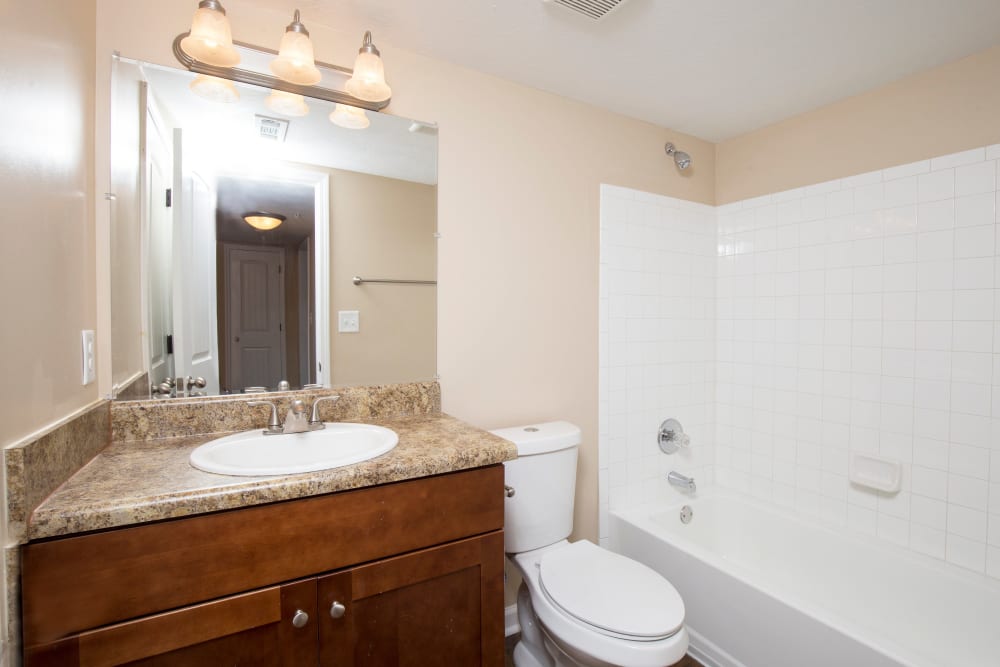 Bathroom with granite countertops at The Crossing at Henderson Mill Apartment Homes in Atlanta, Georgia