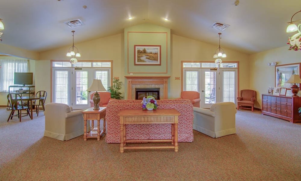 Resident common area with couches, chairs and a fireplace at Randall Residence of McHenry in McHenry, Illinois