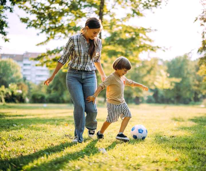 Mother and her child playing football at a park near Kensington Square in Rock Hill, South Carolina